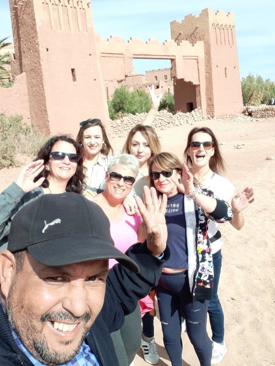 Happy travelers at the gate of Ait Benhaddou kasbah